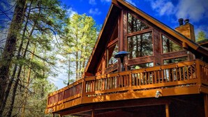 A wooden cabin with a balcony, surrounded by trees. - Chalet Forest Views, 2 kings, fireplace, decks (Pine)