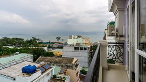 Un edificio alto con múltiples balcones que dan a una vista panorámica de la ciudad.