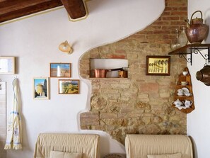 Cozy space with a stone fireplace, wooden shelf, and comfortable sofa.