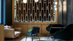 A modern interior with a wine display, leather seating, and a minimalist design.