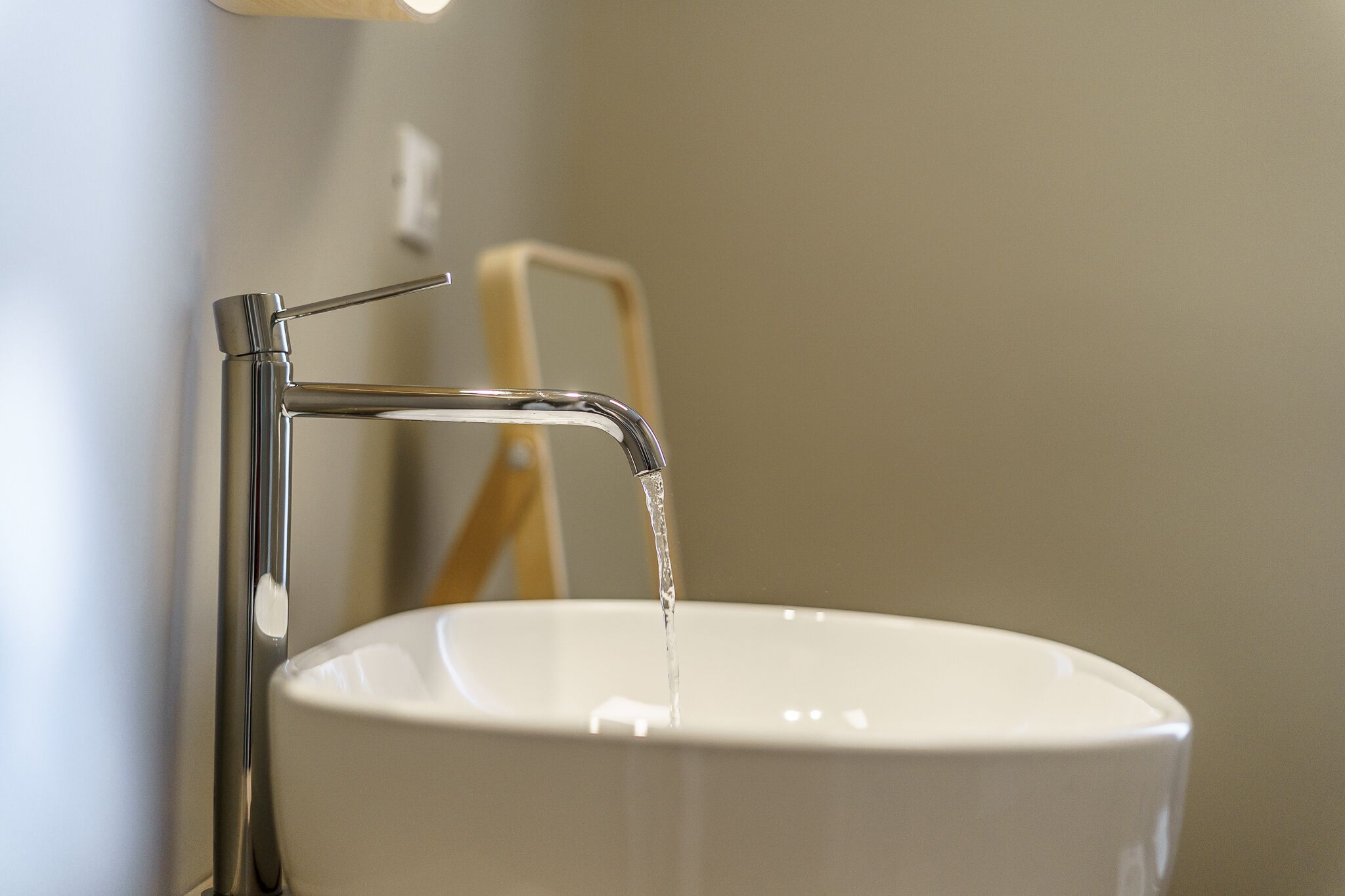 A bathroom sink with a chrome faucet and a white basin.