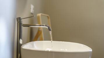 A bathroom sink with a chrome faucet and a white basin.