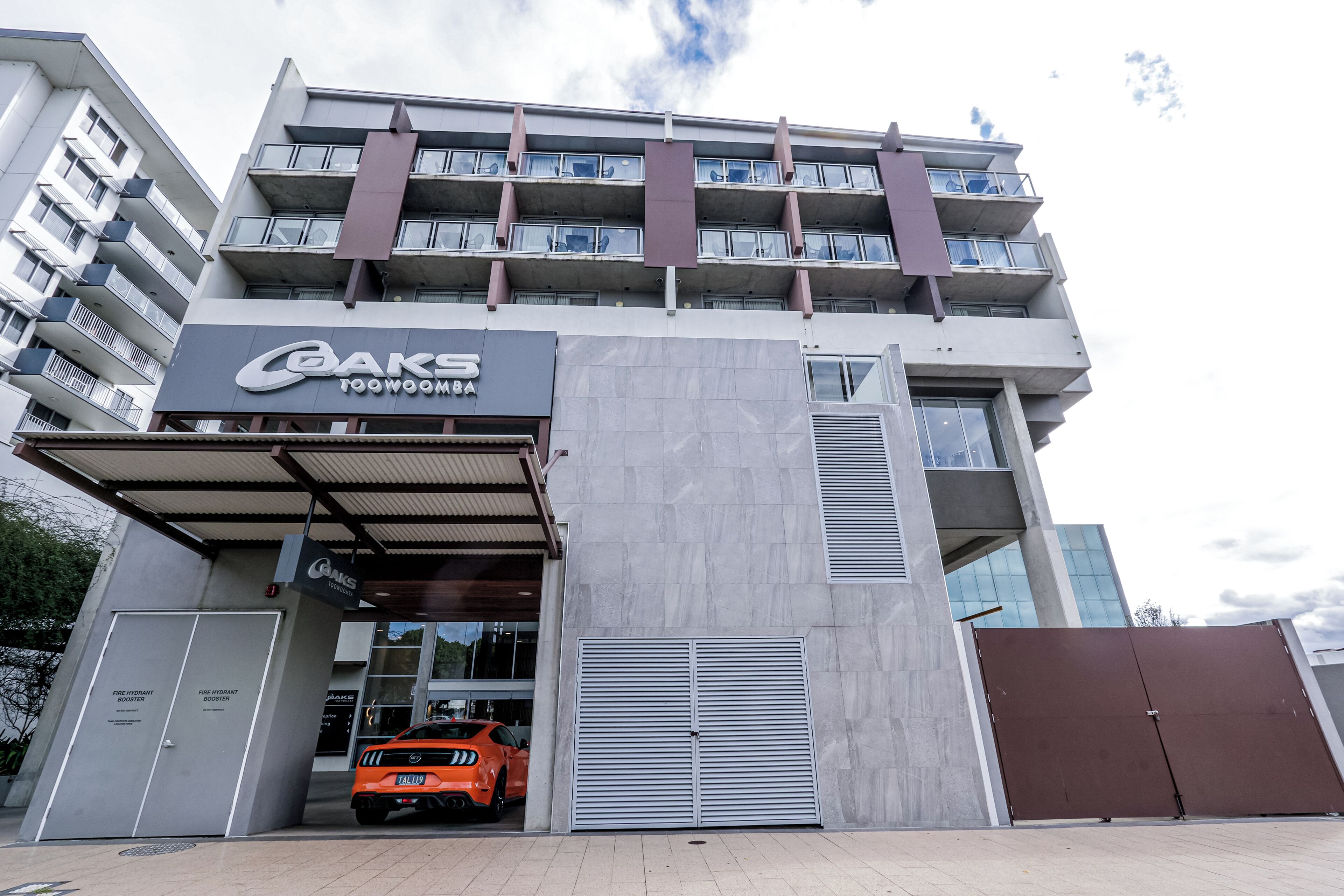 A multi-story building with a prominent sign for 'Baks Toowoomba' on the ground floor.
