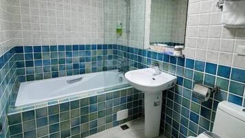 A bathroom with a bathtub, sink, and toilet.