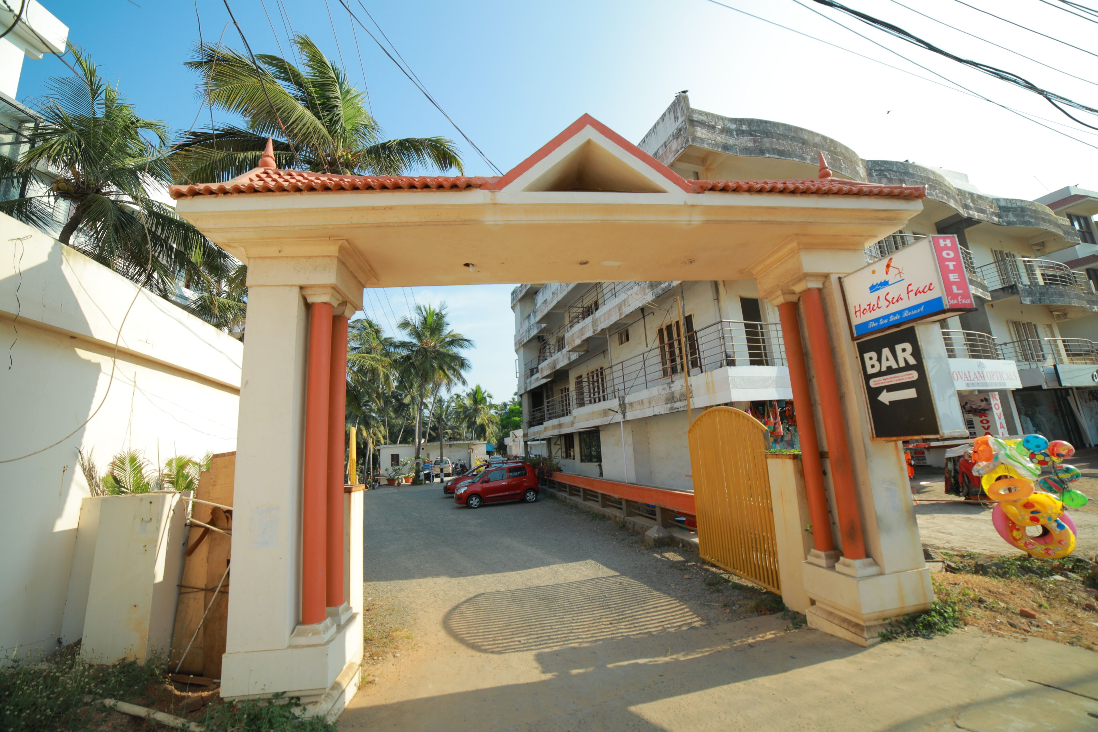 A hotel entrance with a sign for 'Hotel Sea Breeze' and a 'BAR' sign.
