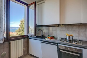 Family Apartment, 2 Bedrooms (Bardolino Garden Pool &Tennis on the) | Private kitchen | Full-sized fridge, microwave, oven, stovetop