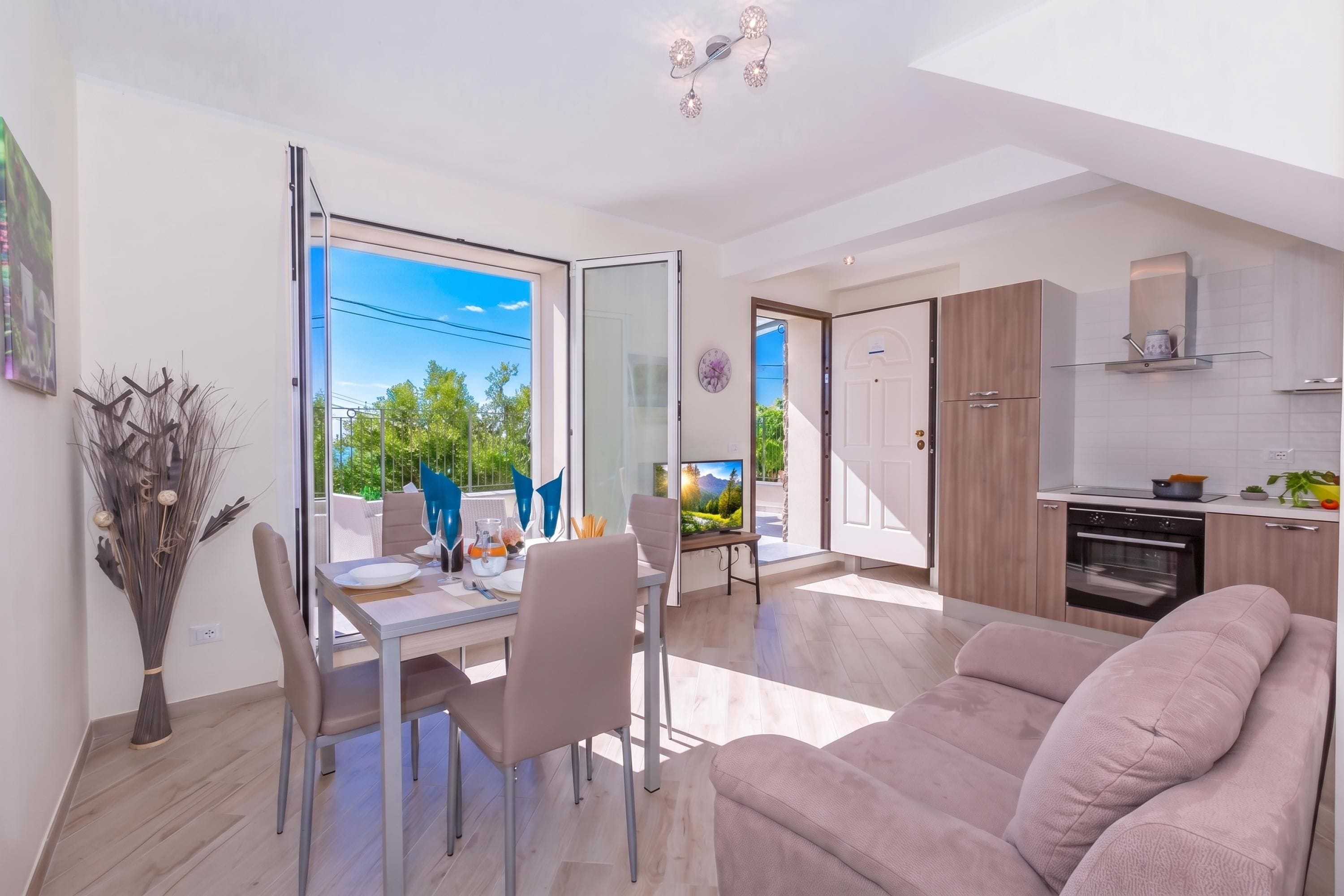 A modern apartment with a dining area, a living room, and a kitchen.