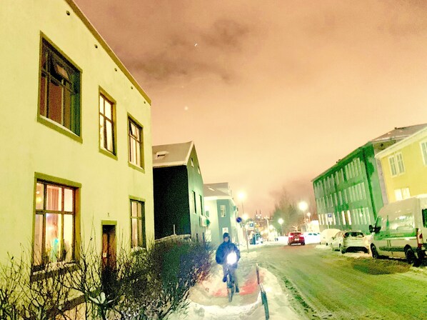 A snow-covered street at night with buildings on either side. - Reykjavik Guesthouse (Reykjavik)