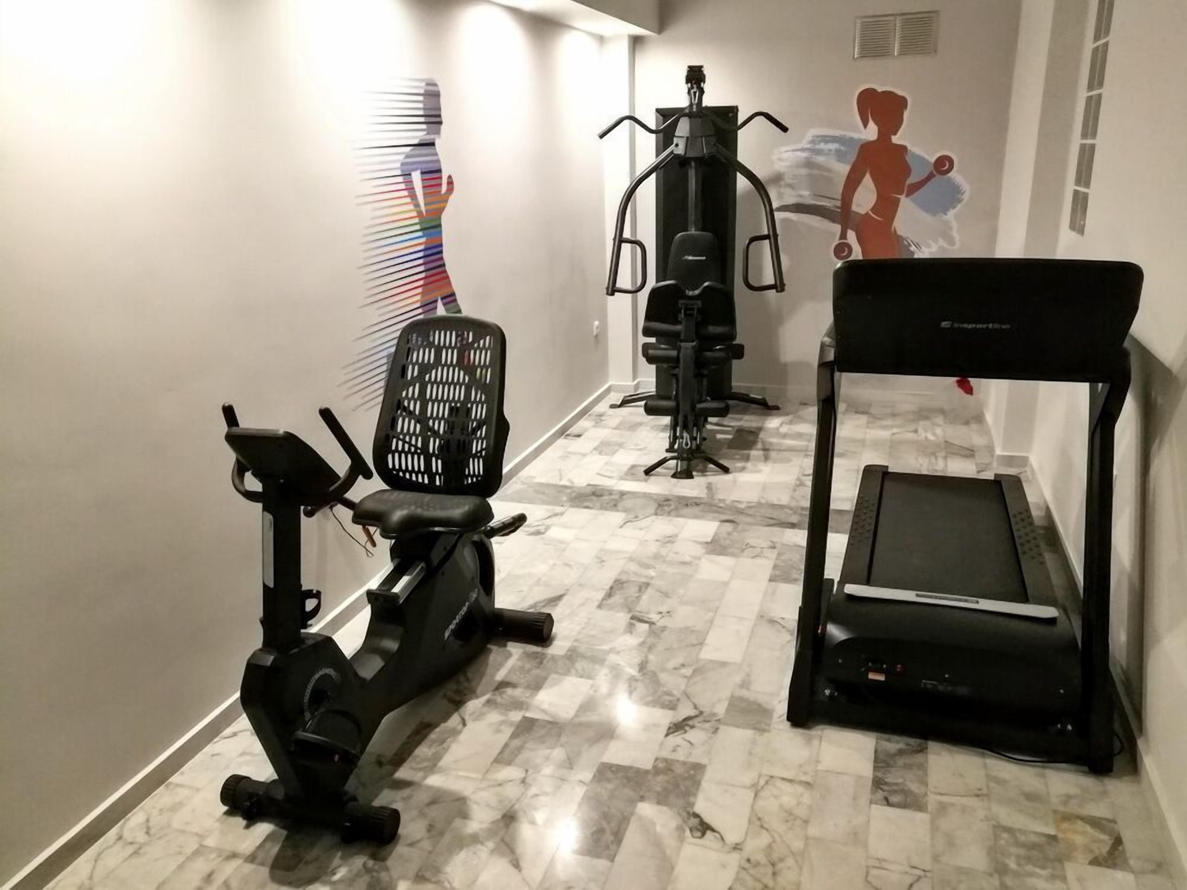 A fitness area with an elliptical, a stationary bike, and a treadmill.