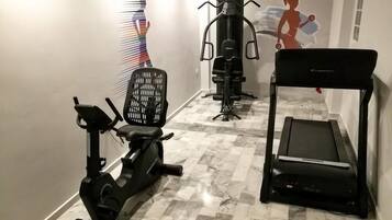 A fitness area with an elliptical, a stationary bike, and a treadmill.