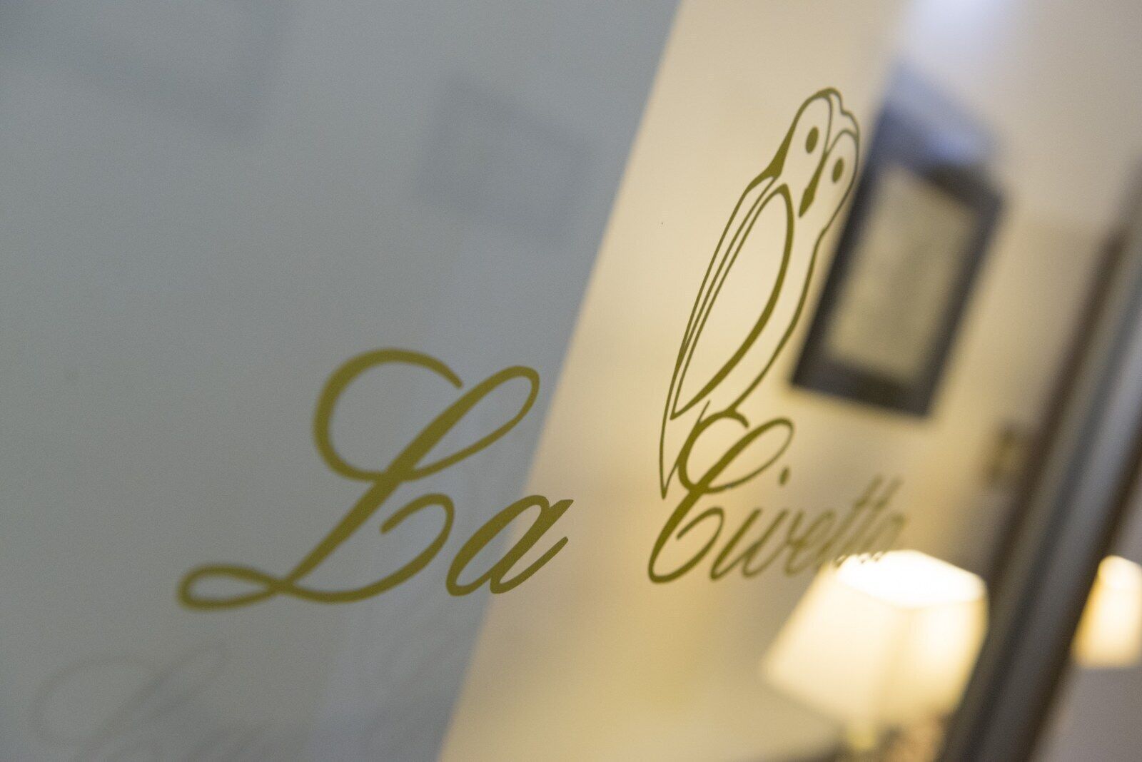 A close-up of a wall with the text "La Cuccia" in a stylized font, indicating a hotel or establishment name.