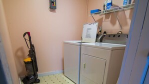 A compact kitchen with a sink, a small refrigerator, and a vacuum cleaner. - Easy access to VAST snowmobile trail system and local mountain bike trails (Randolph Center)