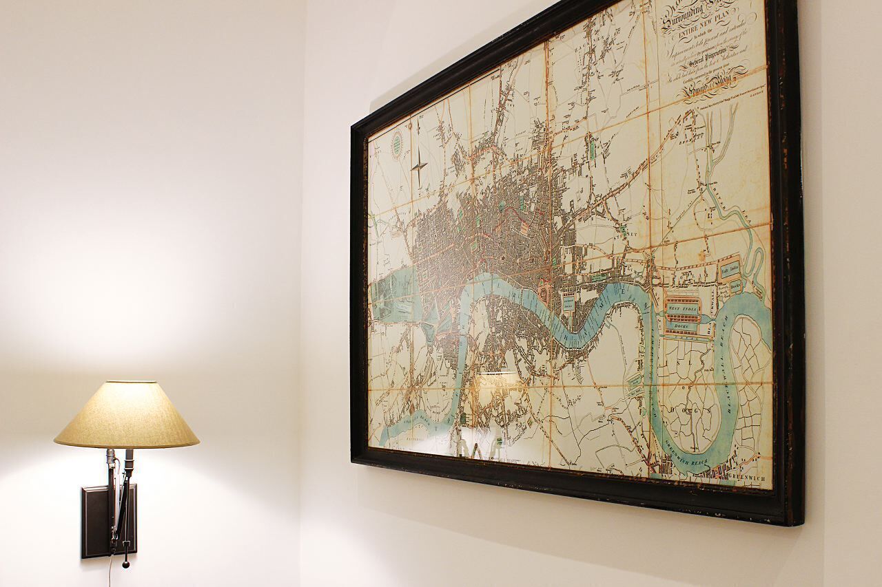 A framed map with a lamp beside it.