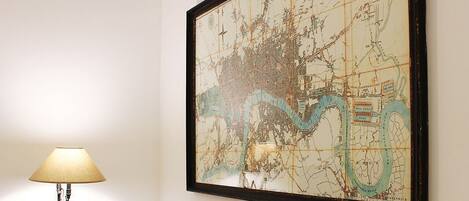 A framed map with a lamp beside it.