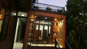 A multi-level building with a glass entrance, a balcony, and a staircase. - Tan Doan An Bang center beach villas (Tp. Hội An)