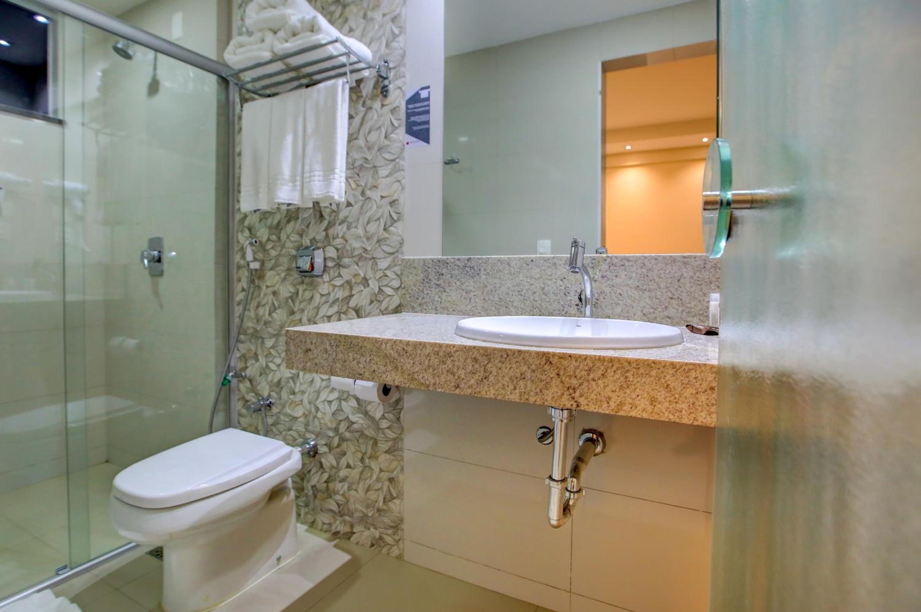 shower, hair dryer, towels, toilet paper