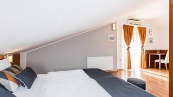 Un dormitorio con una cama grande, un escritorio y una silla.