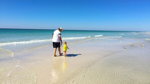A beach scene with a clear sky and calm sea.