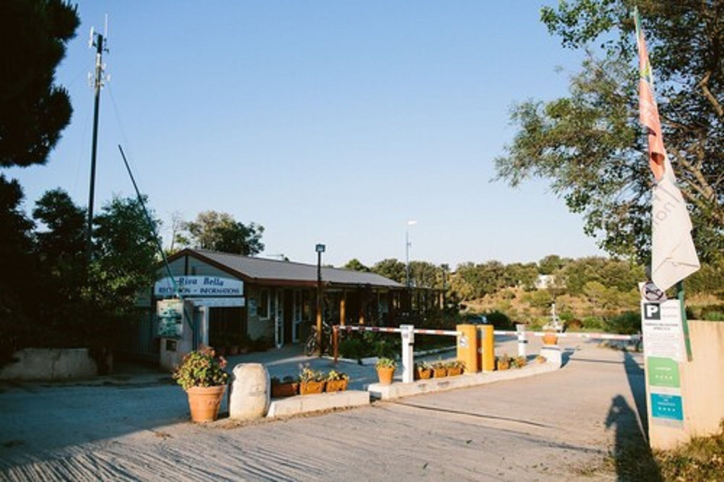 A building with a sign reading "Pia Bella" and a gated entrance.