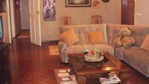 A cozy living room with a sofa, a coffee table, and a rug.