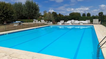 Seasonal outdoor pool, open 9:00 AM to 9:00 PM, pool loungers
