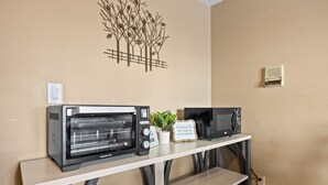 A kitchen counter with a toaster oven, a microwave, and a small potted plant. - Family space+ central +Private entry 2 Bedroom 1 Bath + Bunk Beds + Kitchen  (Colorado Springs)