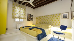 Una camera da letto con un letto, una sedia e una finestra con tende.