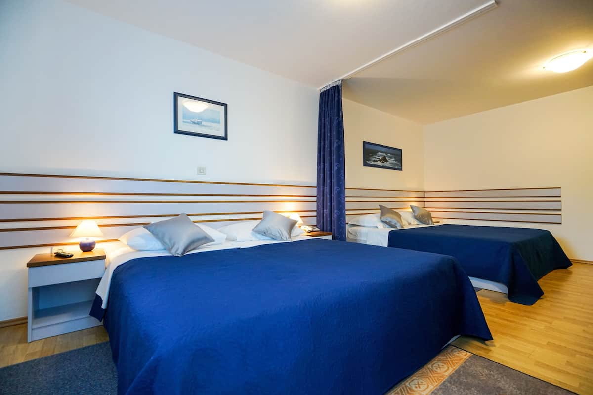 Family Quadruple Room, Balcony, Partial Sea View | In-room safe, desk, free WiFi, bed sheets