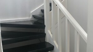 A staircase with white railings and black steps. - Ocean View Condo....IN NEGRIL (NEGRIL)
