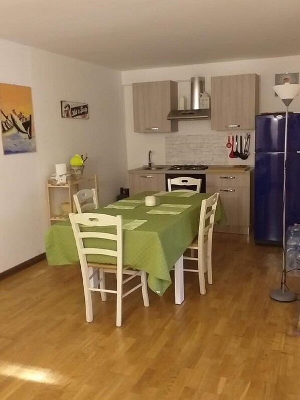 A compact kitchen with a dining area.