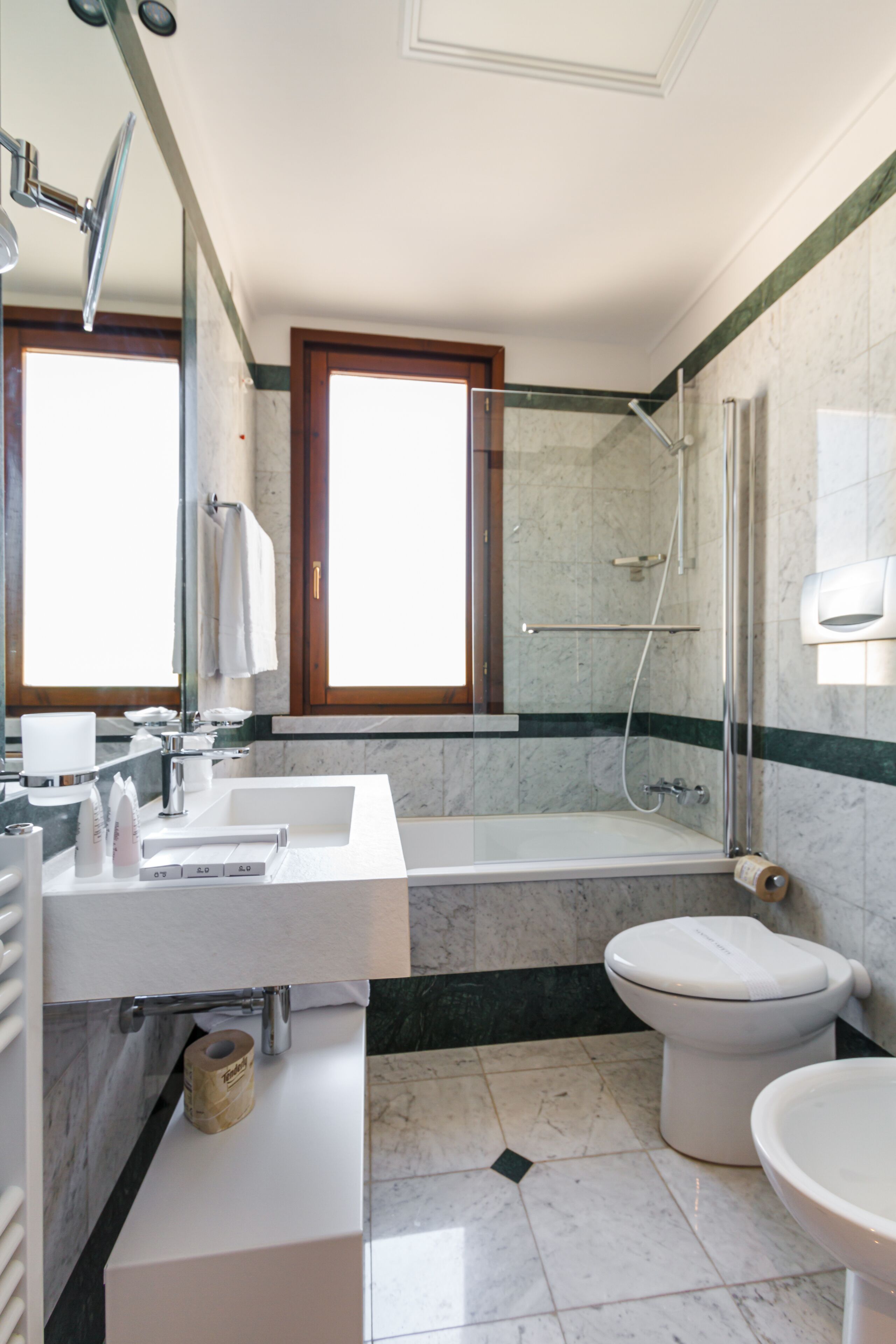 A modern bathroom with a bathtub, toilet, and sink.