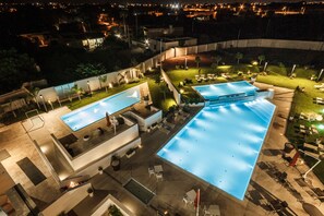 A large outdoor swimming pool with adjacent lounge areas, surrounded by well-maintained lawns and pathways. - SEAWATER HOTEL BIO & BEAUTY SPA  (Marsala)