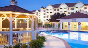 A swimming pool with a gazebo and lounge chairs, surrounded by a building with multiple balconies. - Modern units at the Suites at Hershey Resort (Hershey)