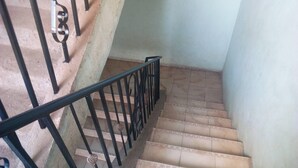 A staircase with a metal railing and patterned steps. - Sirlo Hotel (Thika)