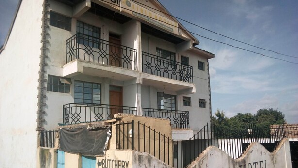 A two-story building with balconies and a sign indicating it is the Sirlo Hotel. - Sirlo Hotel (Thika)
