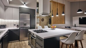 A modern kitchen with a central island, stainless steel appliances, and pendant lighting. - Private pool Villa with sea view at 250 m from the sea/beach (zakynthos)
