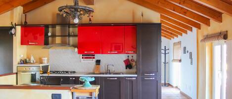 A spacious kitchen with high ceilings, a central island, and modern appliances.