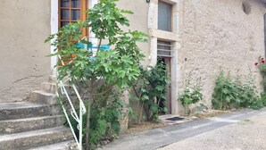A building with a stone facade, a wooden door, and a small window.