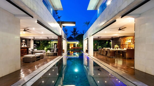A modern hotel interior with a central swimming pool, a bar area, and a dining space. - 5 Bedroom Holiday Villa in Seminyak with Private Pool, Bali Villa 2001 (Bali)