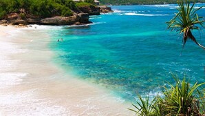 A beach with clear turquoise water, sandy shore, and lush greenery. - Beautiful 5 Star Holiday Villa in a Prime Location in Seminyak, Villa Bali 2046 (Bali)