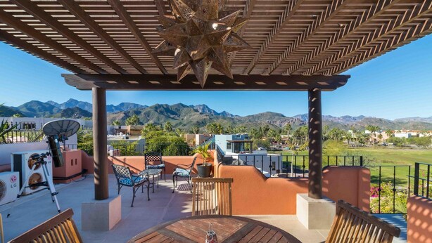 A covered outdoor area with a star-shaped light fixture, a telescope, and a view of mountains. - Casa Bella 2BR by Casago (Loreto)