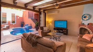 A living room with a pool, a TV, and a fireplace. - Casa Bella 2BR by Casago (Loreto)