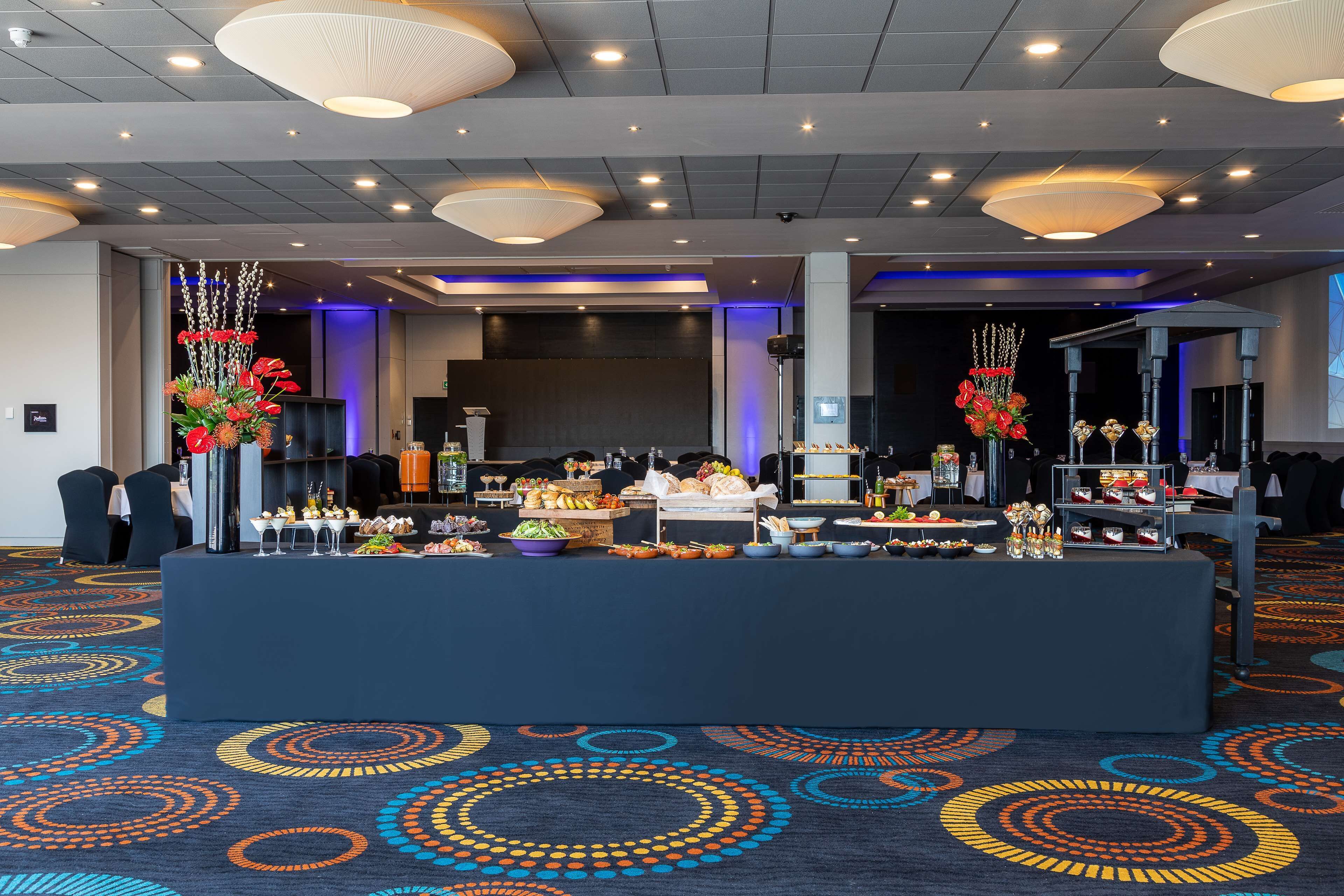 A buffet setup with various food items and a decorative centerpiece.