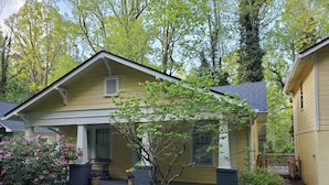 A two-story house with a front porch, a small tree, and a well-maintained lawn. - 1920's and 2020's...the best of both! (Saluda)