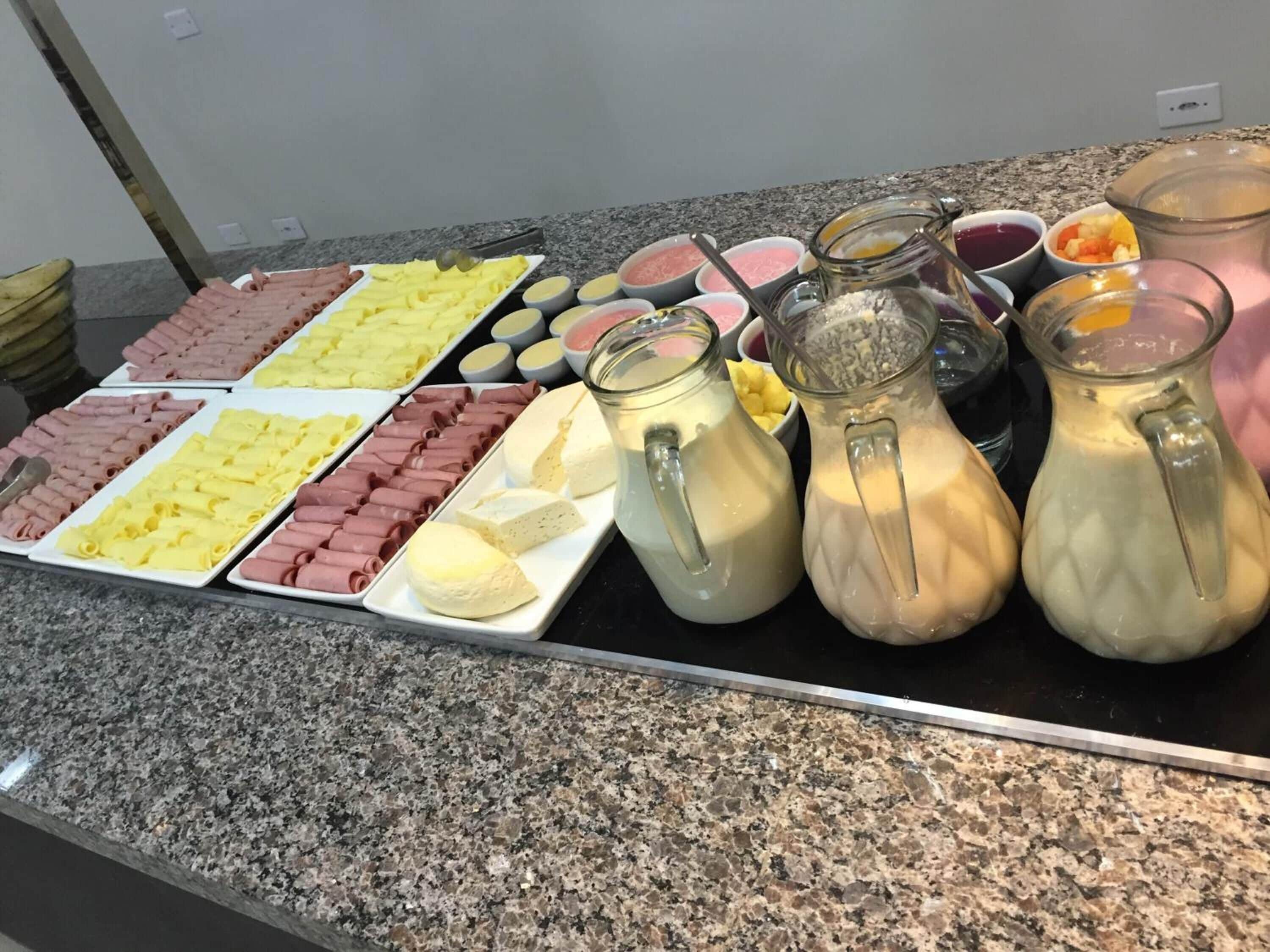 A buffet with various food items and beverages.