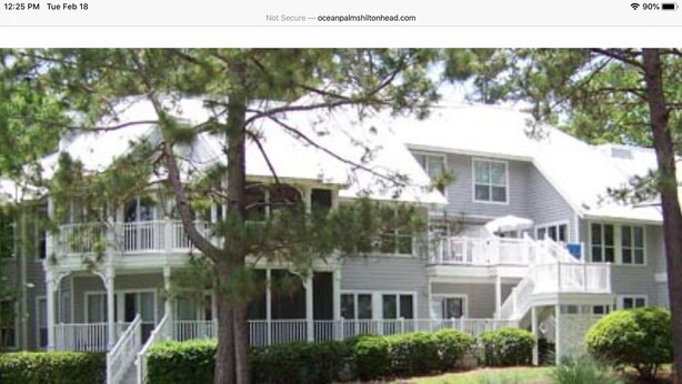 A two-story building with a balcony and a staircase leading to the upper floor. - Desired Resort on Hilton Head Island (3 BD, 3BA Condo near beach) (Hilton Head)