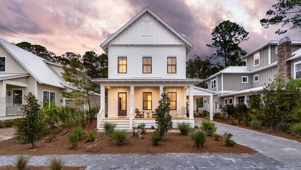A two-story house with a front porch, a covered patio, and a landscaped front yard. - Southern Sand: beach house with beautiful forest views (Santa Rosa Beach)