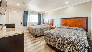 A hotel room with two beds, a desk, a TV, and a bathroom. - ERTH INN by AGA - Mojave (Mojave)