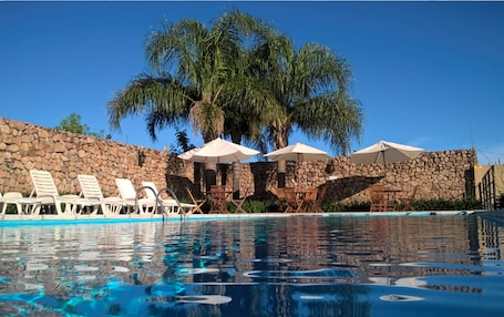 Seasonal outdoor pool, open 9:00 AM to 10:00 PM, pool umbrellas. Hotel Hostal del Espinillo