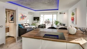 A modern living room with a wooden coffee table, a sofa, and a TV.